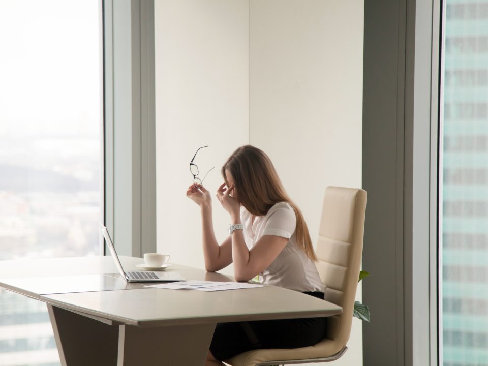 Exhausted businesswoman sitting at office