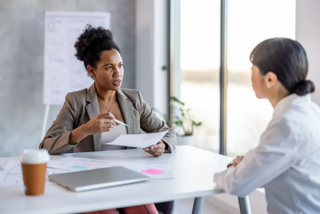Transgender employee reviewing an unexpected negative performance evaluation