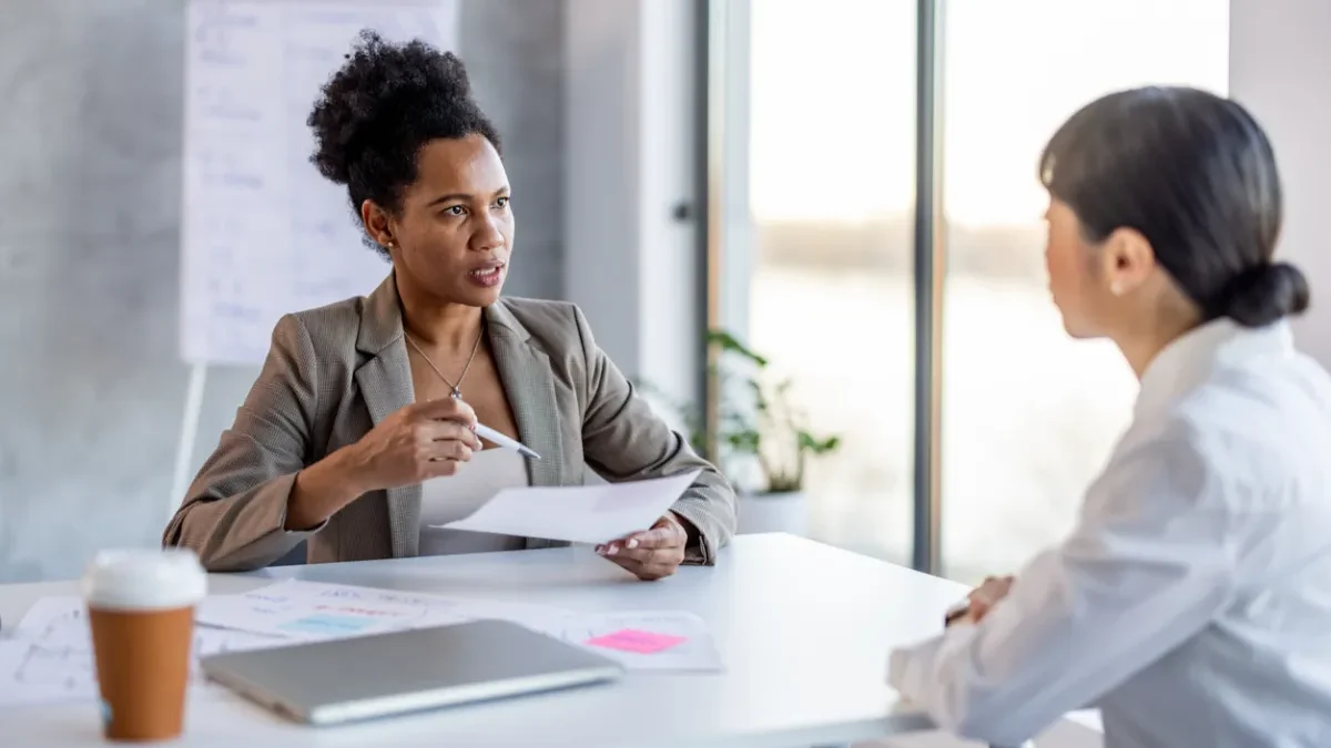 Transgender employee reviewing an unexpected negative performance evaluation