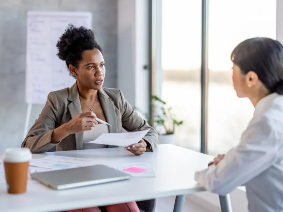 Transgender employee reviewing an unexpected negative performance evaluation